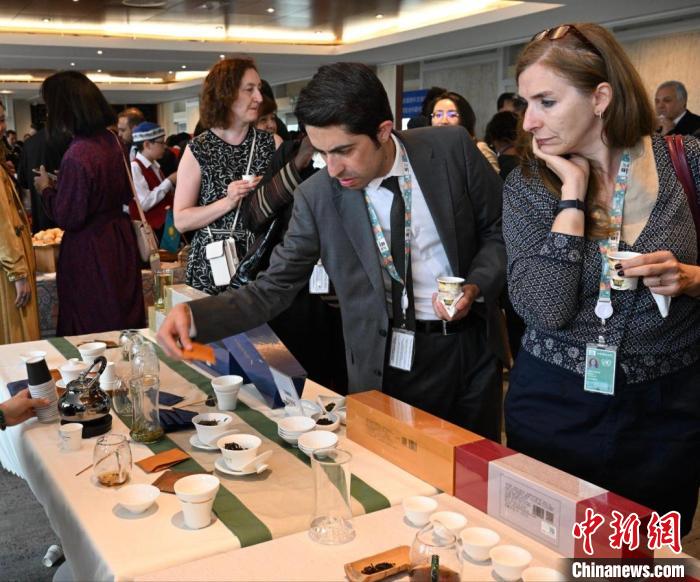 現(xiàn)場觀眾觀看中國展臺茶藝表演、了解茶文化。　靖樹 攝