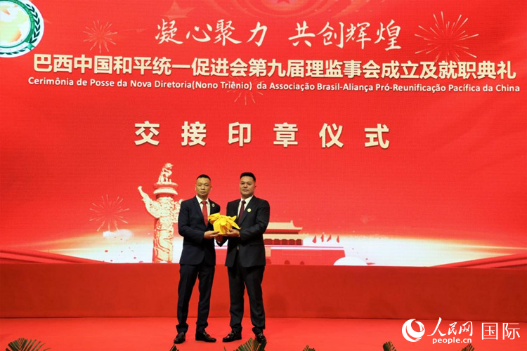 就職典禮中，巴西和統(tǒng)會第七屆和第八屆會長王俊曉與新任會長張小春交接印章。人民網(wǎng)記者 時元皓攝