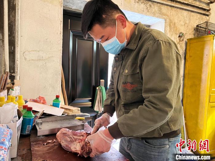 圖為雪豹“奶爸”史壽軍正在準備投喂雪豹的食材?！●R銘言 攝