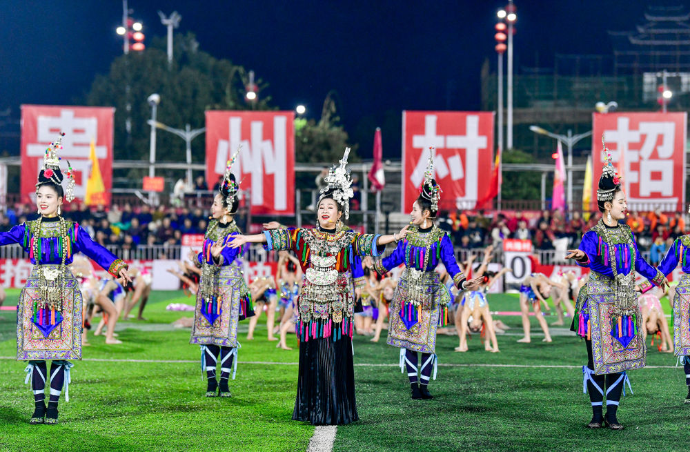 2025年3月14日，2025年貴州“村超”40強(qiáng)交叉賽在榕江“村超”足球場(chǎng)舉行，演員在比賽間隙表演侗族大歌，民族文化伴隨著體育賽事成功“出圈”。圖片來源：新華社