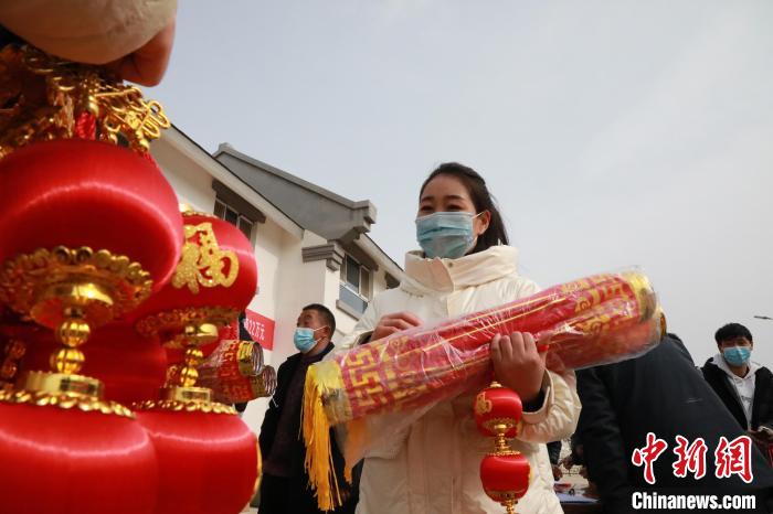 27日，蘭州新區(qū)為舟曲避險搬遷移民送“春節(jié)包”，楊周馬草前往領(lǐng)取，紅色寓意來年的日子紅紅火火?！∥航ㄜ?攝