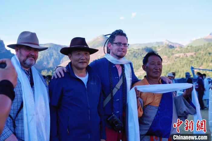 圖為當(dāng)?shù)孛癖娕c外籍?dāng)z影師合影留念?！●R銘言 攝