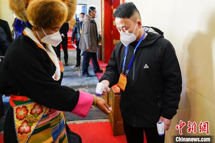 政協(xié)委員測(cè)體溫后入場(chǎng)?！〗w波 攝