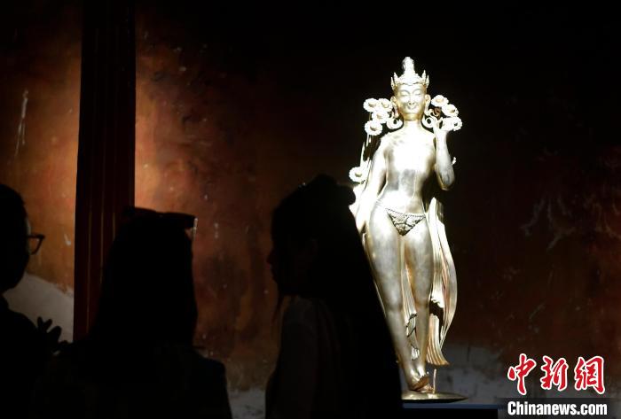 圖為觀眾正在欣賞展覽中的雕塑作品《八萬四千年》?！±盍?攝