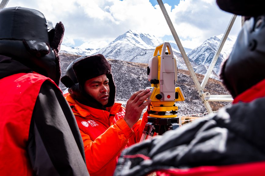 2023年11月30日，西藏自治區(qū)那曲市索縣榮布至丁青縣巴達35千伏線路工程負(fù)責(zé)人黃小洪（左二）現(xiàn)場開展線路弧測量教學(xué)。趙清鵬攝