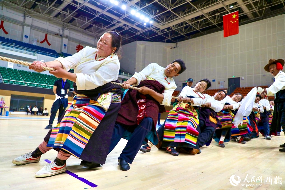 身著民族服裝的農(nóng)牧民選手在拔河比賽現(xiàn)場(chǎng)。